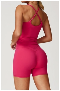 Detailed back view of dusty pink yoga set showing crisscross straps and V-shaped seam