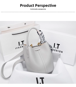 Detail of light grey pebbled leather bucket bag with printed silk scarf wrap handle