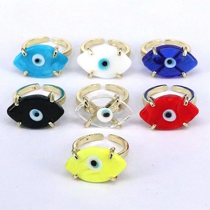 Detail of adjustable evil eye rings in seven colors with gold plated metal settings