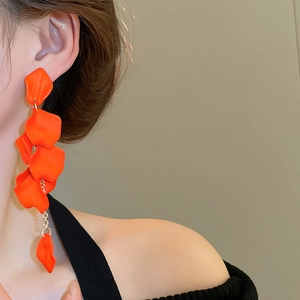 Long orange rose petal tassel earrings shown worn on a model for a vintage aesthetic