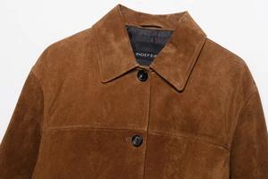 Close-up of brown suede jacket lapel with premium black resin button and fabric texture