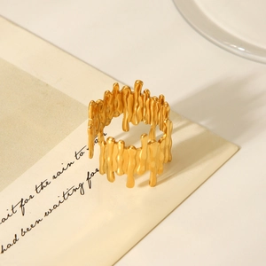 Detailed shot of irregular 18K gold stainless steel ring with a melted lava texture