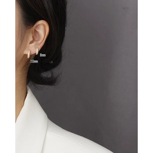 Close-up of 8mm and 10mm gold s925 silver hoop earrings with triple row micro-pave stones