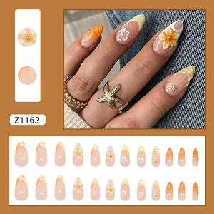 Sunset orange floral press-on nails with 3D starfish charms and pearl gradients
