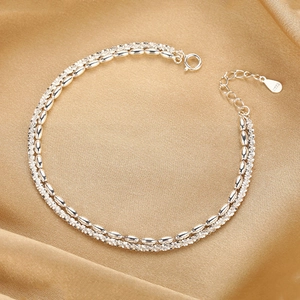 Elegant double-layered S925 sterling silver beaded bracelet on gold silk fabric