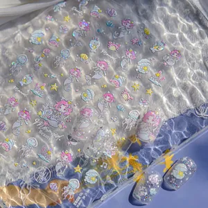 Macro view of iridescent mermaid nail stickers with glitter seashells and sea stars