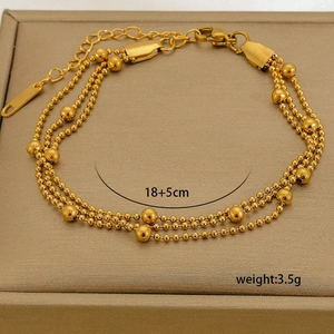 Detail of 18K gold plated multi-layer beaded chain bracelet with 18+5cm size label