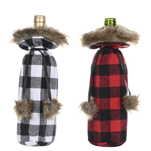 Black and red buffalo plaid wine bottle covers with faux fur trim and tassels