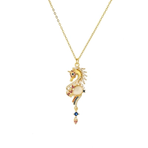 Detailed close-up of seahorse pendant with colorful stones and a small pearl