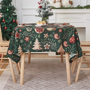Detailed view of dark green Christmas tablecloth with festive trees and stars pattern