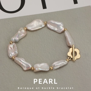Baroque irregular freshwater pearl bracelet featuring a gold flower OT buckle closure