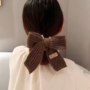 Brown knitted bow scrunchie with cute bear patch, winter hair accessory for women