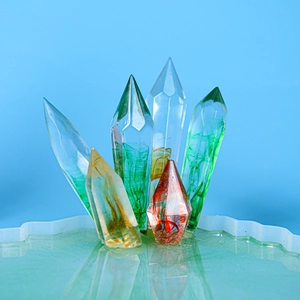 Macro detail of colorful epoxy resin crystal pillars in a wavy blue display base