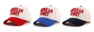 Detailed close-up of three baseball caps with American Honey embroidery in various colors