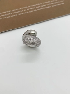 Detail view of silver zircon ring showing polished metal and micro-pave setting texture