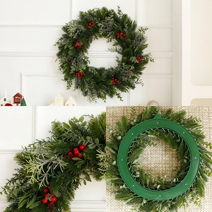 Artificial Christmas wreath with red berries and eucalyptus leaves on a sturdy green frame