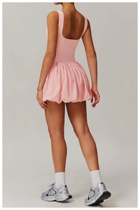 Rear view of pink sports dress showing deep U-back design and bubble hem structure