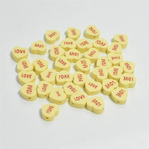 Bulk 10mm yellow heart-shaped clay beads with red LOVE print for DIY jewelry making