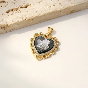 Gold heart-shaped shell cameo pendant necklace featuring a mother of pearl angel design