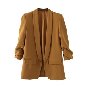 Detailed view of caramel casual blazer featuring ruched sleeves and flap pocket design