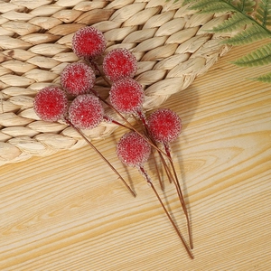 Close-up of frosted red Christmas berries with realistic sugar-like texture and brown stems