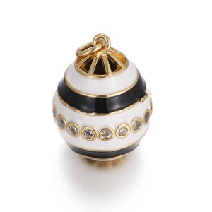 Macro shot of gold sphere evil eye charm with white enamel and clear cubic zirconia