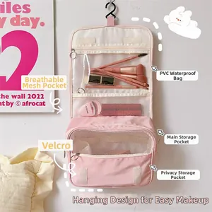 Pink hanging toiletry bag with waterproof PVC pockets and mesh organizers for travel