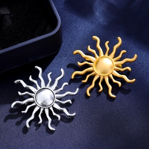 Retro sunburst brooches in gold and silver finish on elegant dark blue silk fabric