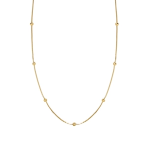 Minimalist gold plated snake bone necklace with small beads on a white background