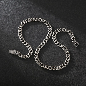 Macro detail of retro cuban link chain with secure industrial jewelry clasp closure