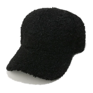 Detailed view of black fuzzy sherpa fleece texture on a warm winter baseball cap