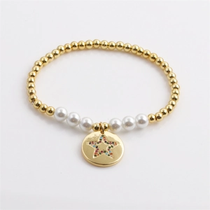 Golden bead stretch bracelet with white pearls and a celestial star charm for women