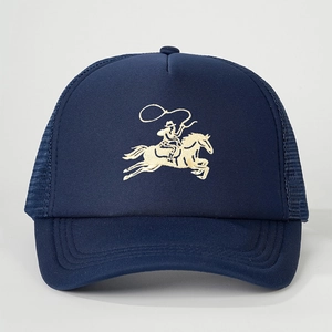 Detail view of the embroidered cowboy on a navy mesh trucker cap with curved brim