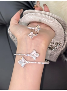 Detail of 18k gold plated iris flower bracelet with zircon and white mother of pearl inlay
