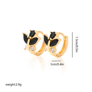 Detail of gold butterfly hoop earring with black gemstones and clear zircon accents