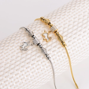 Micro shot of gold and silver snake chain bracelets with unicorn charms and zircon beads