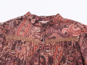 Close-up of bohemian paisley chiffon blouse featuring lace splicing and black buttons