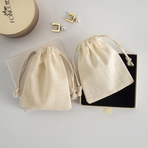 Detail of linen drawstring pouches and jewelry gift box with black flocking insert