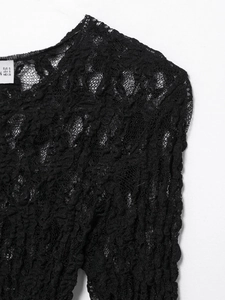 Detail of black lace top neck with brand size tag showing EUR S USA S MEX 26 label