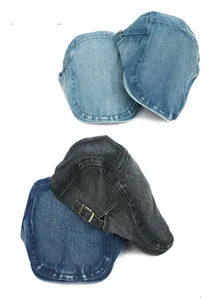 Detail of vintage washed denim flat caps with adjustable metal buckles in multiple colors
