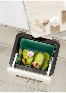Macro detail of a wall-mounted kitchen bin with a wide opening on a cabinet door