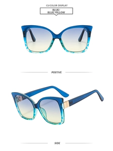 Detail view of cat eye sunglasses showing blue-yellow gradient lenses and gold metal accents