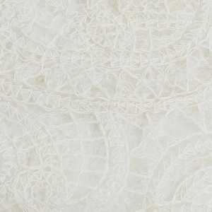 Detailed macro view of premium white lace knit fabric with intricate hollow patterns