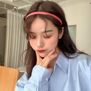 Minimalist matte coral pink slim headband worn by a model for a fresh daily look