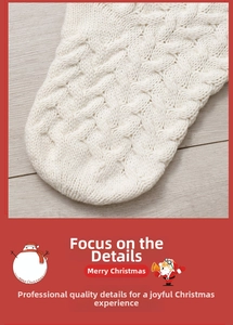 Close-up of white cable knit Christmas stocking with thick wool texture on wood floor