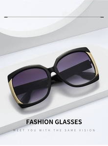Detail of square black sunglasses with purple gradient lenses and gold V-shaped metal accents