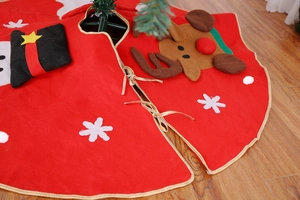 Detailed embroidery of reindeer and snowflakes on a red felt Christmas tree skirt