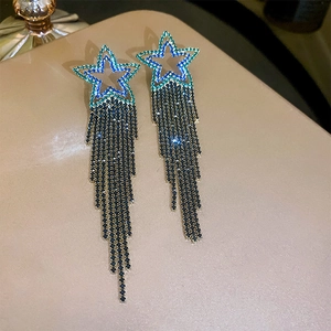 Detail of star-shaped tassel earrings featuring alloy crystals on champagne leather
