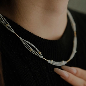 Elegant multi-strand pearl beaded necklace with French vintage style and golden accents