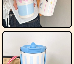 Detail of light blue insulated tumbler featuring lid with handle and pop-up straw